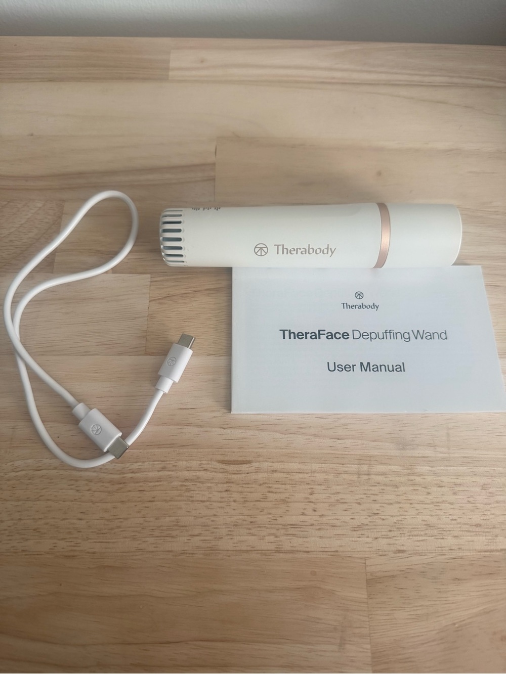 Therabody TheraFace Depuffing Wand in White with Rose Gold Trim